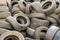 Rubber tires in a landfill. Old wheels from cars. Recycling rubber. Garbage dump with damaged wheels. Environmental pollution. A