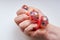 Rubber toy antistress in a woman`s hand on a white background