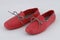 Rubber waterproof red shoes with decorative lace against a white background