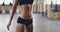 Rubbing chalk at gym female fitness personal trainer at after abs and flat stomach workout or exercise. Strong, fit and