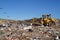 Rubbish being compacted into a landfill.