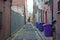 Rubbish bins lined up in narrow alley