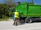 Rubbish cleaner man working green truck