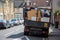 A rubbish collection van filled up with household waste parked on a street