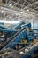 Rubbish on conveyor belt in recycling plant workshop