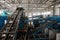 Rubbish on conveyor belt in recycling plant workshop