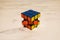 Rubik`s Cube on a marble plate, showing blue, yellow and orange