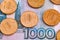 Ruble coins on one thousand rubles banknote