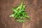 Ruccola leaf on wooden table, heap of fresh green arugula leaves collection top view