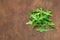 Ruccola leaf on wooden table, pile of fresh green arugula leaves collection top view