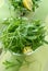 Rucola in glass bowl on green napkin