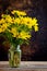 Rudbeckia bright yellow flowers bouquet on dark background