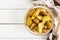 Ruddy Baked potato wedges with garlic on a white background