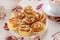 Ruddy baked rolls on a white plate with a cup of fruit apple tea