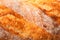 Ruddy crust of bread as an abstract background. Texture