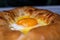 Ruddy and freshly fried khachapuri with egg