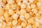 Ruddy golden popcorn as background. Top view, closeup.