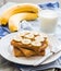 ruddy toast with peanut butter, sliced â€‹â€‹bananas, milk, breakfast