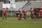 Rugby action on muddy field