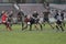 Rugby action on muddy field