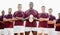 Rugby, field and portrait of team with ball and smile standing together with confidence in winning game. Diversity