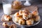 Rugelach with jam filling on plate with milk on wooden background - a traditional European pastry