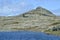 Rugged bedrock hill next to lakeshore in Newfoundland