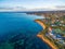 Rugged coastal cliffs and luxury homes near the ocean.