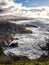 Rugged coastline with mist and clouds