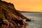 Rugged Cornish coastline at Porth Nanven on sunny evening, Cornwall, England