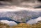 Rugged dramatic mountain landscape in norway cloudy dramatic day with calm lake