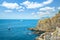 The rugged granite coastline of Cinque Terre at the village of Riomaggiore, Italy on the Ligurian Sea