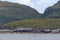 Rugged Isle of Raasay landscape behind emerging basking shark fins