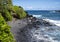 Rugged lava shoreline next to the Black sand beach on the Island of Maui in the State of Hawaii.