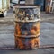 Rugged metal barrel serves as trashcan, showcasing industrial style