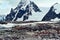 Rugged mountains and cliffs with lots of penguins on Peterman Island, Antarctic Peninsula