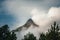 Rugged Nevado De Colima mount peak surrounded by smoky clouds in Mexico