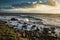 Rugged rocky shoreline on Isle of Wight island, with powerful white-capped waves crashing against it