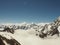 Rugged snow covered mountains rising up above thick clouds at sunrise, Caucasus, Kabardino-Balkaria, Bezengi region