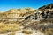 The rugged steep hills of the badlands of southern Alberta on a bright autumn day.