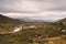 Rugged wild mountain landscape in norway cloudy and calm river