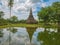 Ruin of Pagoda in Wat mahathat Temple Area and reflection in the water At sukhothai historical park