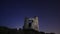 Ruin windmill in the night sky. startrails timelapse.