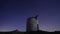 Ruin windmill in the night sky. startrails timelapse.