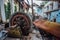 Ruined abandoned hydroelectric power plant. Rusty generator at machinery. Demolished roof. Gagra, Abkhazia