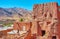 The ruined abandoned red adobe building in terrace Abyaneh village