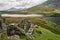 A ruined brick farm house overlooks the fishing lake of Llyn Dywarchen in the Snowdonia National Park.