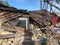 Ruined, brick, residential building. The ruins of a collapsed mansion in the forest. Demolition of an old house with an excavator