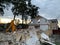 Ruined, brick, residential building. The ruins of a collapsed mansion in the forest. Demolition of an old house with an excavator