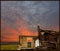 Ruined house, dramatic, colorful sky, and a flower field